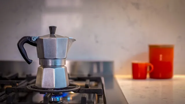 A stove top with a coffee pot on top of it.