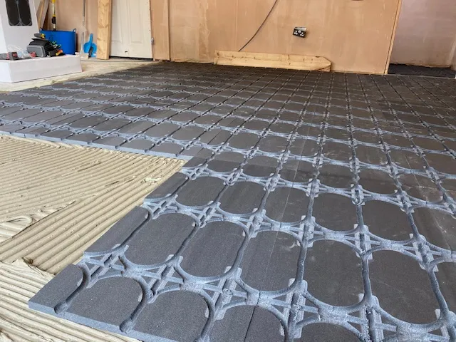 A room with a tile floor and a wooden door.