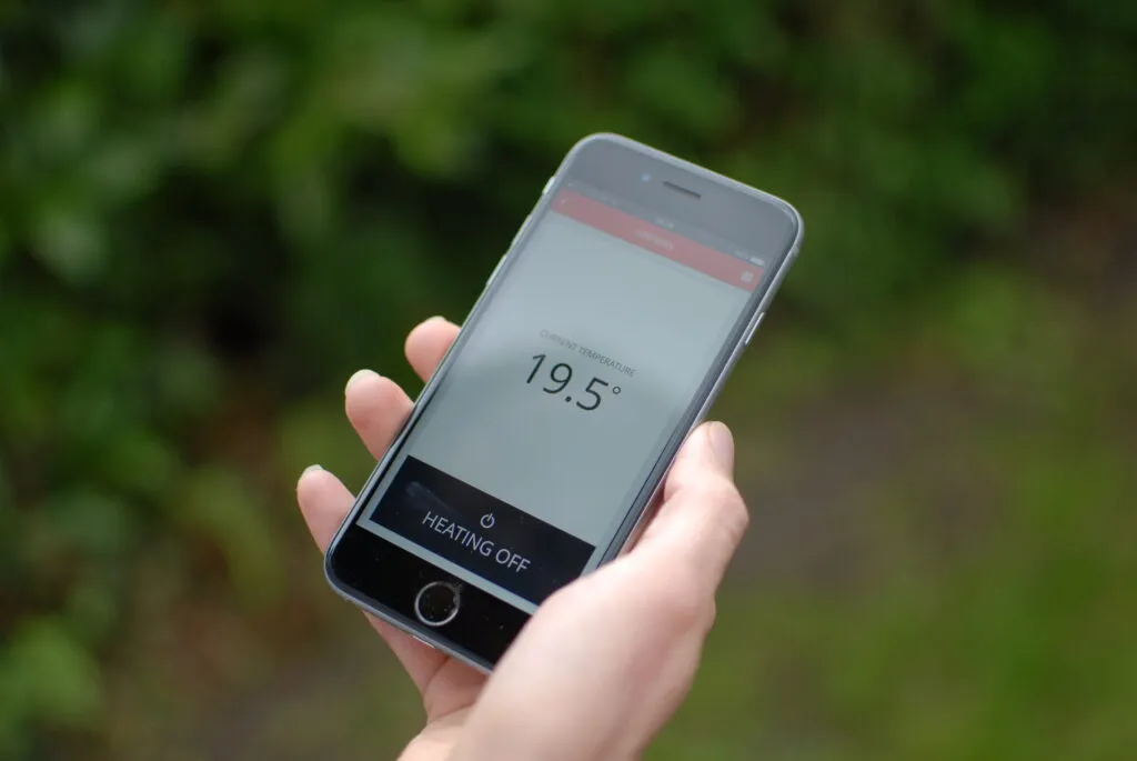 A person holding a smart phone in their hand.