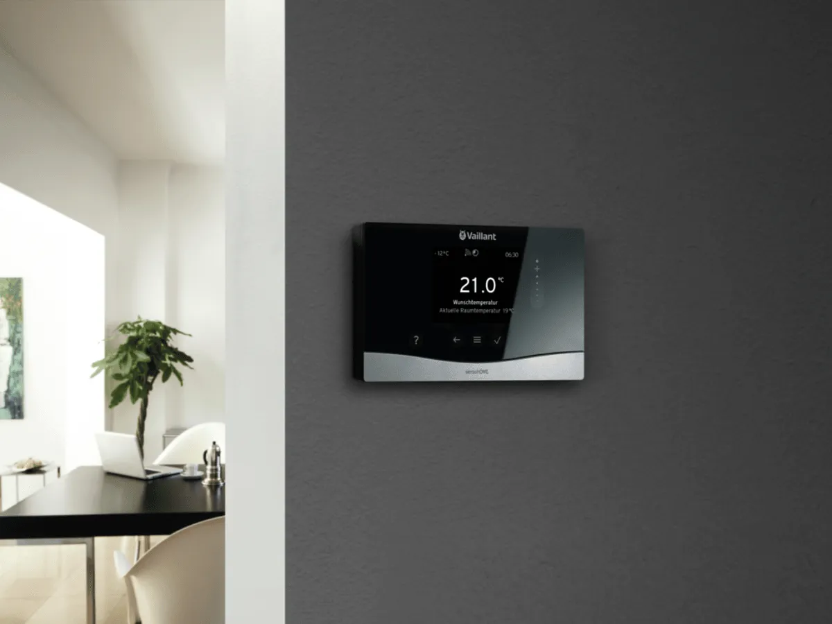 A smart thermostaer mounted on a wall.